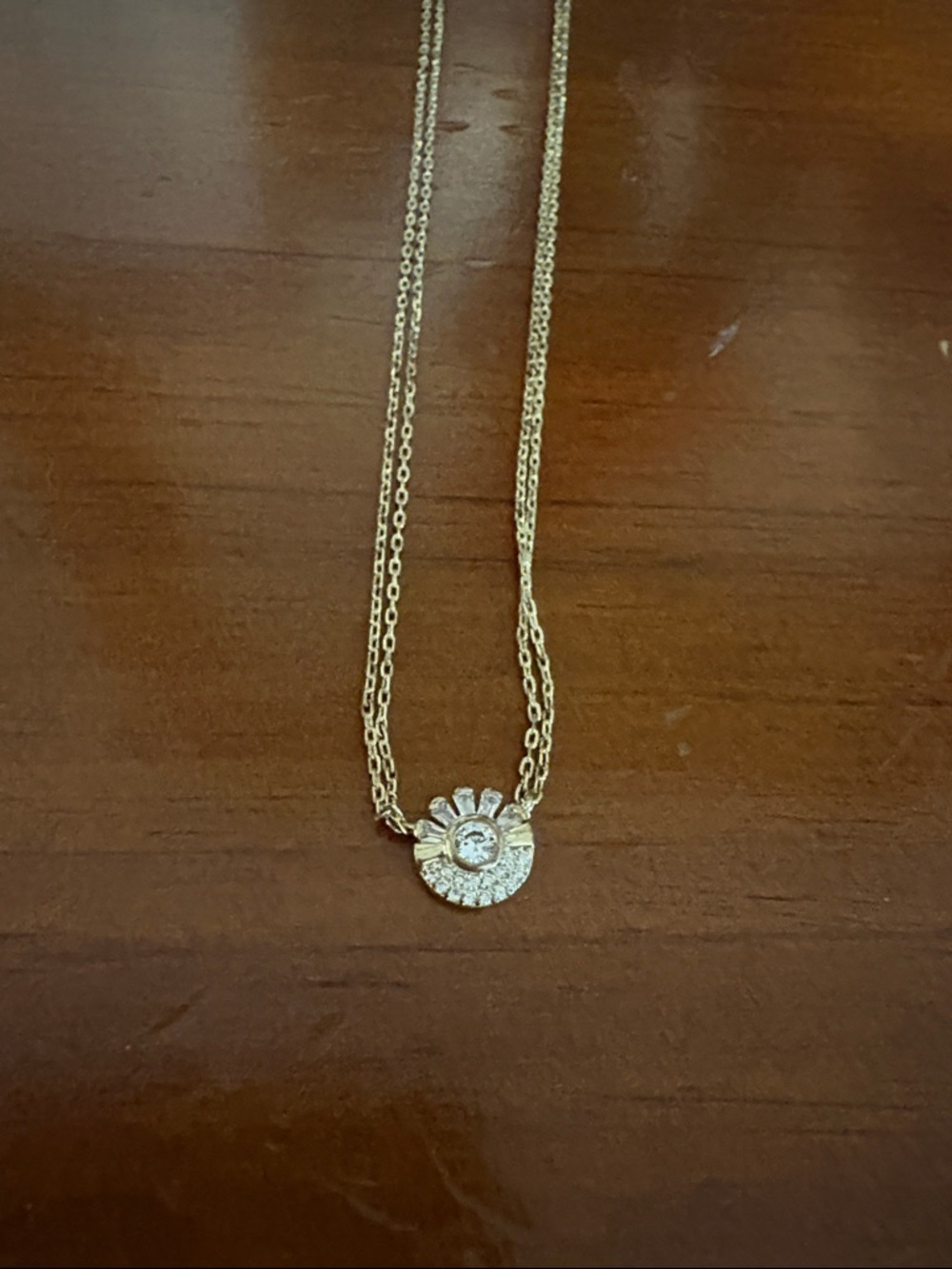 Gold Tone Sunburst Pendant Necklace with Clear Stone